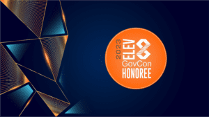 Navy Blue Background with Orange Circle in the middle with text Elev8 GovCon Honoree