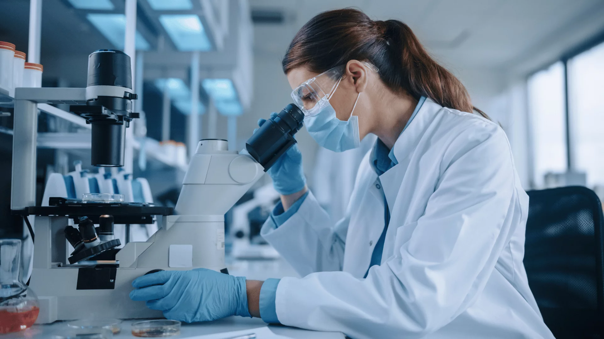 Scientist examining something with a microscope