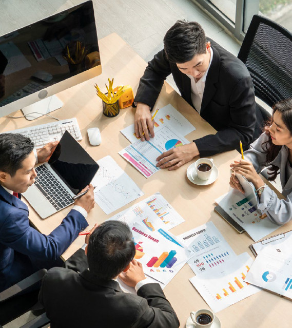 Business people around a table for a financial meeting. 